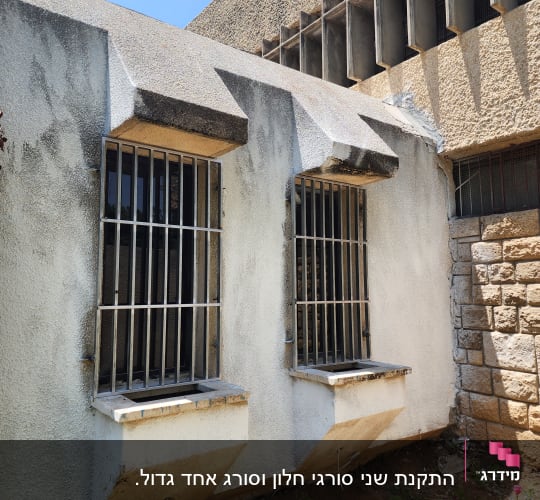 חלונות עם סורגים על קיר בטון חיצוני